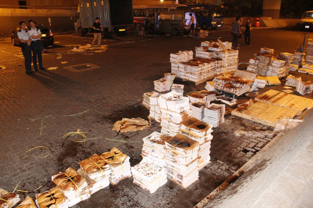 Bundles of Apple Daily in Hung Hom are drenched with soy sauce in the early hours of yesterday. Photo: SCMP Pictures