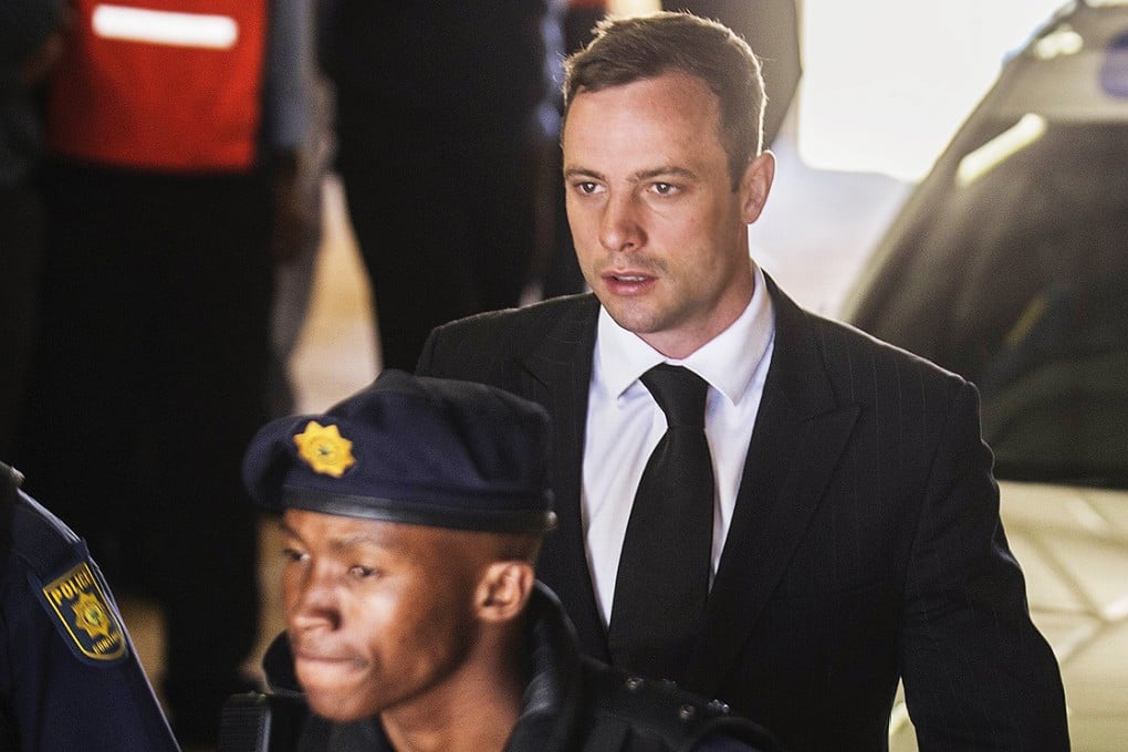 South African police lead Paralympic athlete "Blade Runner" Oscar Pistorius into an armoured vehicle headed for Pretoria Central Prison yesterday. Photo: AFP