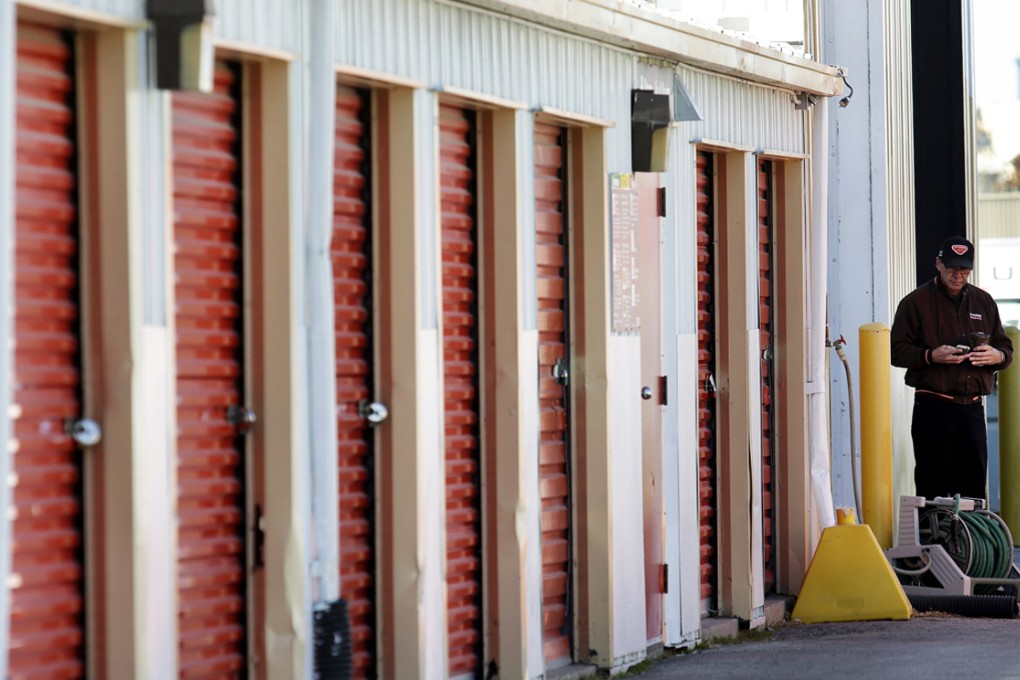An employee stands near the scene where infant remains were found in various states of decomposition in Winnipeg, Manitoba. Photo: Reuters
