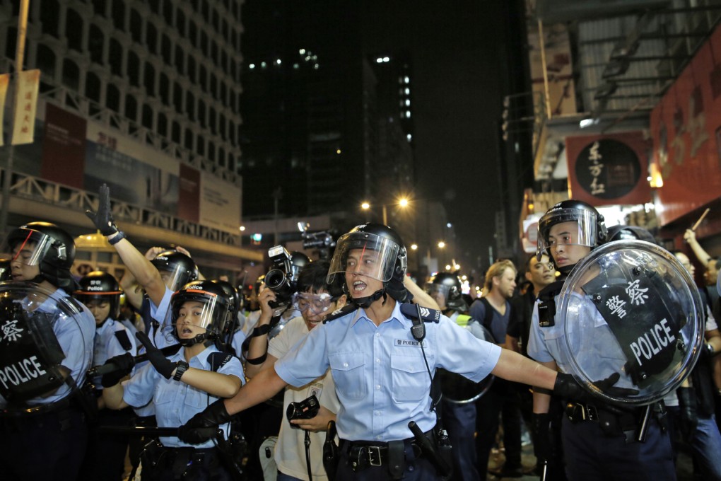 Police officers advance on a protest encampment in Mong Kok over the weekend. The prolonged tensions have taken a toll on frontline officers. Photo: AP