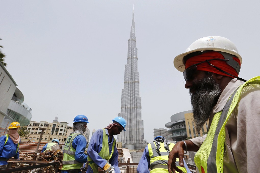 Labourers work near the Burj Khalifa, the tallest tower in the world, in Dubai in this May 9, 2013 file photo. Photo: Reuters