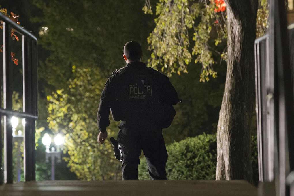 A Secret Service agent responds on the North Lawn of the White House after a man jumped the fence on Wednesday. Photo: AP