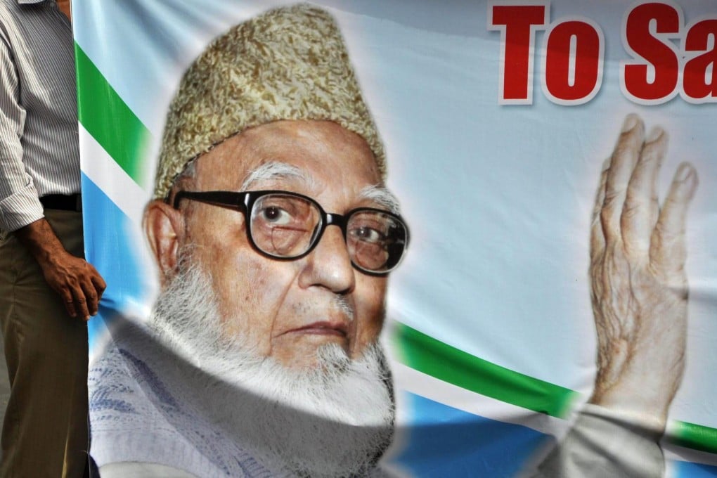 A supporter holds a poster of Ghulam Azam at a protest against his imprisonment. Photo: EPA