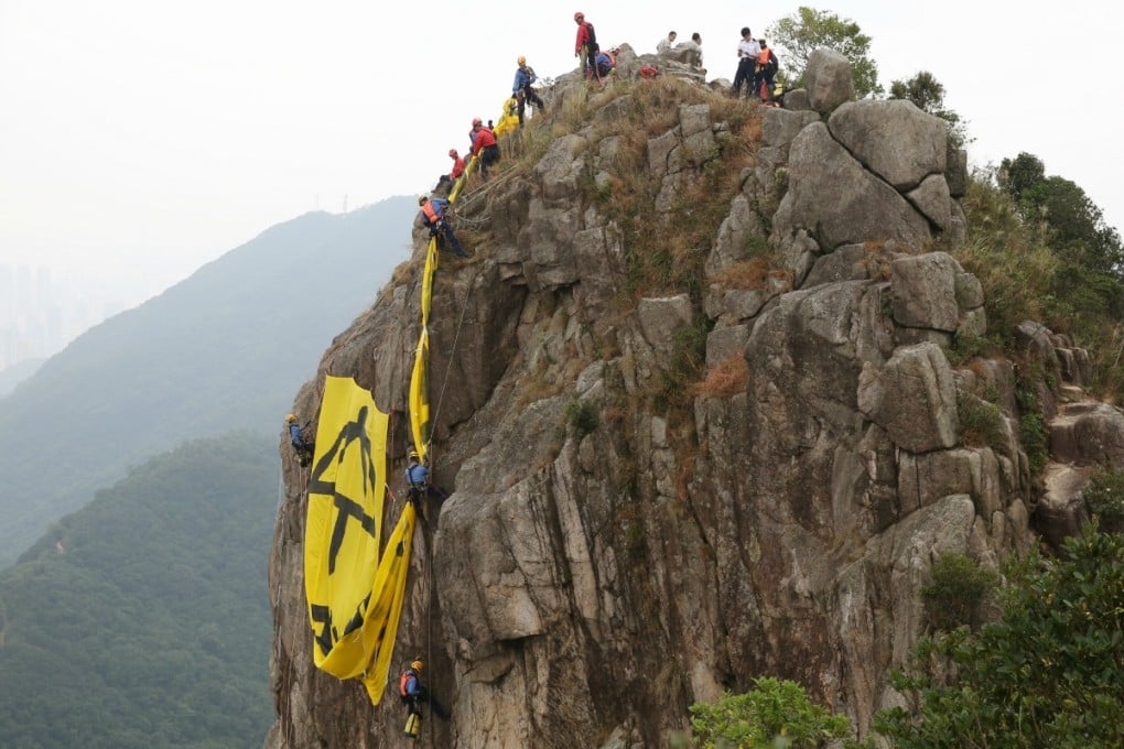 Government services remove the banner on Friday morning. Photo: Robert Ng