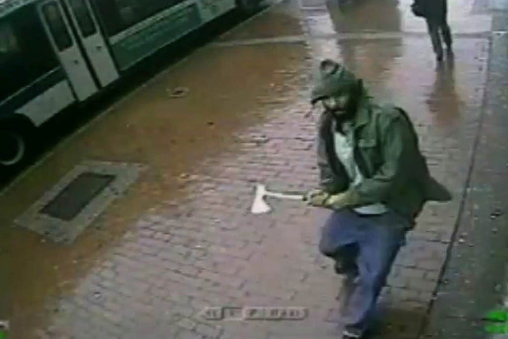 An unidentified man approaches police officers with a hatchet on Thursday in this screengrab taken from video provided by the New York Police Department. Photo: AP