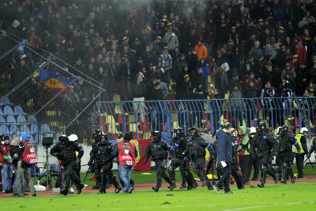 Riot police come on to the pitch during the  match between Slovan Bratislava and Sparta Prague at the Pasienky Stadium in Bratislava. Photo: AP