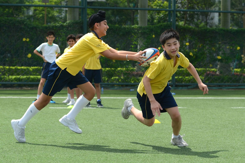 Youngsters take part in this year’s first Po Leung Kuk Tackling Life Rugby Fun Day at King’s Park. Photos: HKRFU