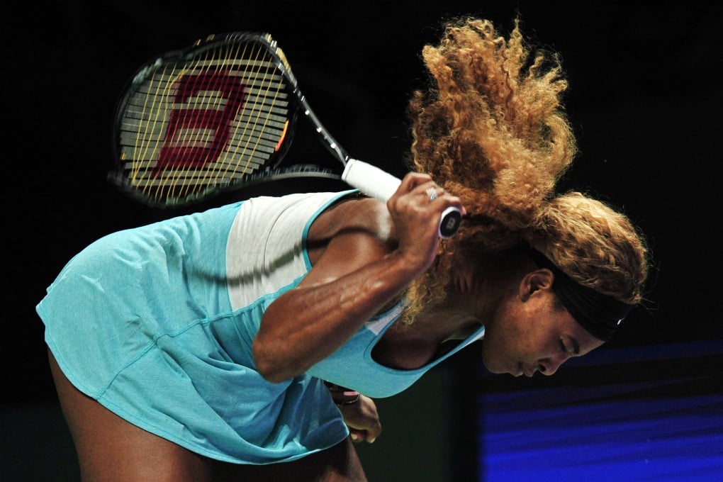 Serena Williams smashes her racket in frustration during her singles semi-final against Denmark's Caroline Wozniacki in Singapore. Photo: Xinhua