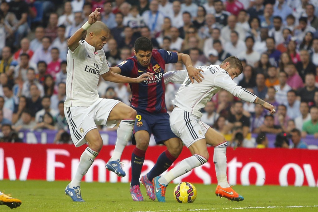Barcelona's Luis Suarez is shut down by  Real Madrid's Karim Benzema and  Sergio Ramos. Photo: AP