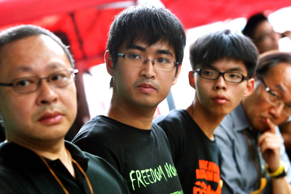 Occupy Central co-founder Benny Tai, Federation of Students' secretary-general Alex Chow, Scholarism convenor Joshua Wong and lawmaker Alan Leong explain the decision to protesters in Admiralty. Photo: Sam Tsang