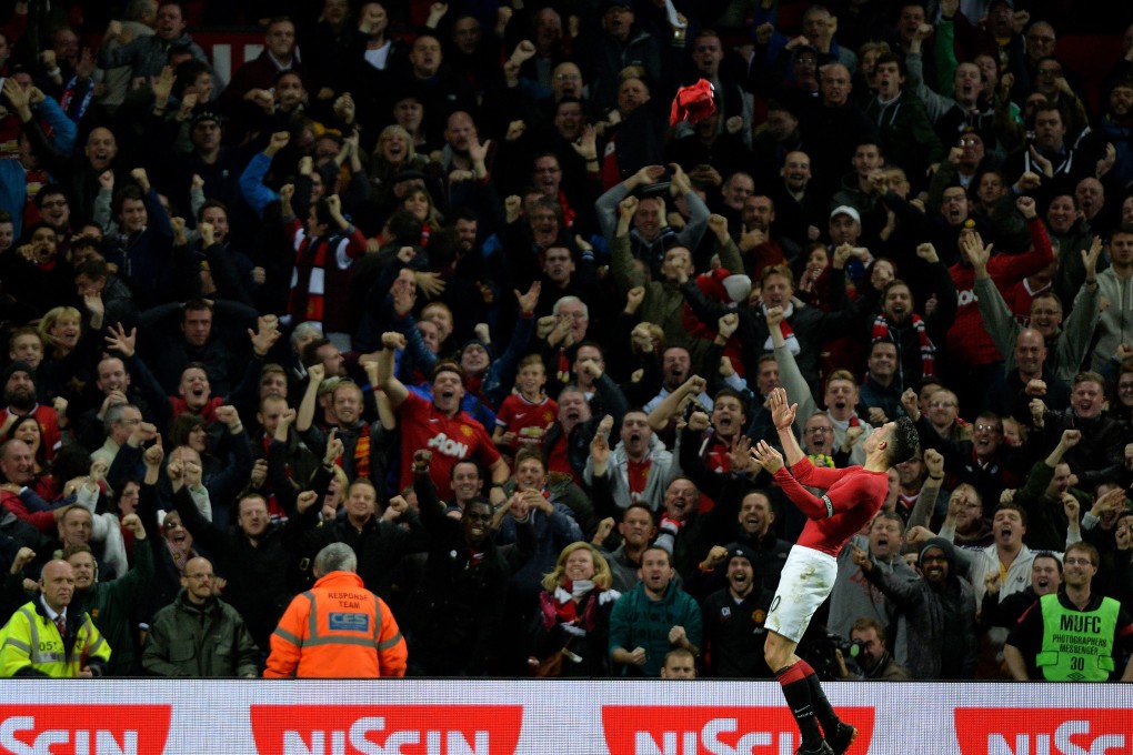 Manchester United's Robin Van Persie celebrates scoring the equaliser by throwing his shirt into the air. Photo: EPA