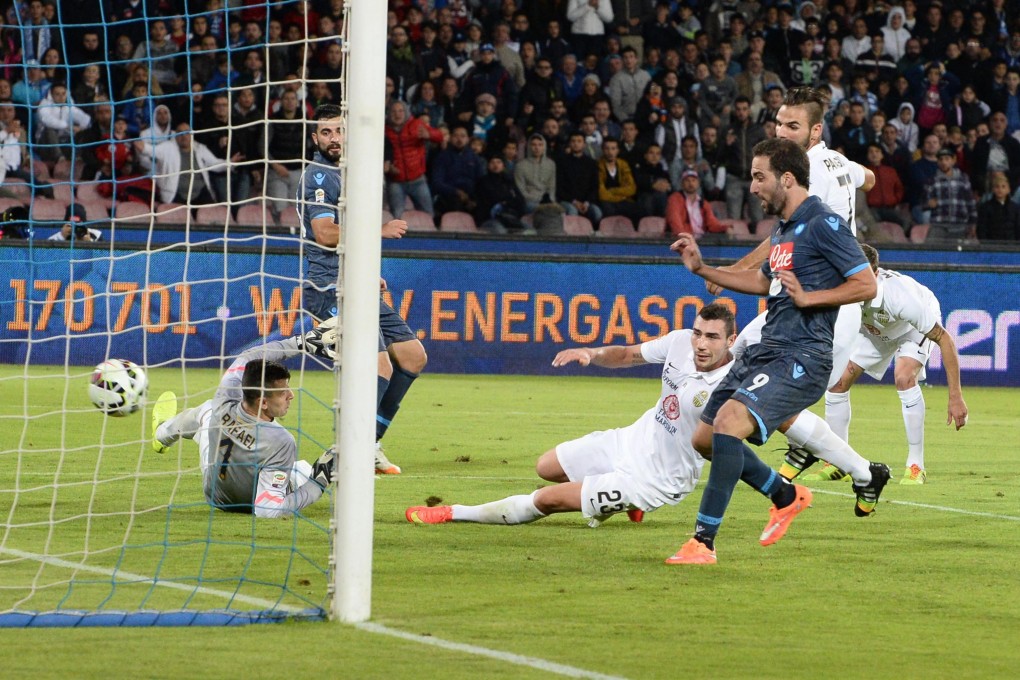 Napoli striker Gonzalo Higuain scores the second of his three goals during his team's 6-2 victory against Verona. Photos: EPA