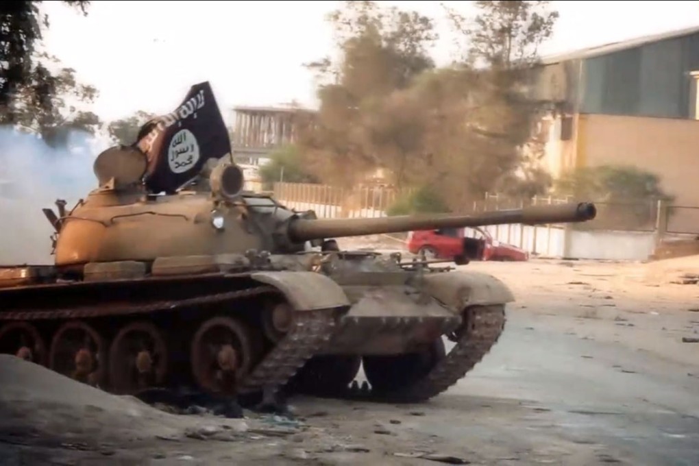 A tank, belonging to the Ansar al-Sharia militant group, flying the trademark Jihadist flag during a battle in the Libyan city of Benghazi. Photo: AFP
