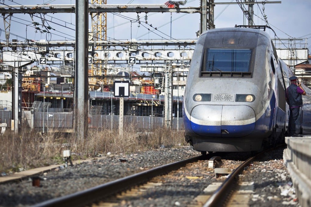 A TGV Duplex high-speed train, operated by Societe Nationale des Chemins de Fer (SNCF) and manufactured by Alstom SA, arrives alongside the railway platform at Gare de Montpellier-Saint-Roch in Montpellier, France.