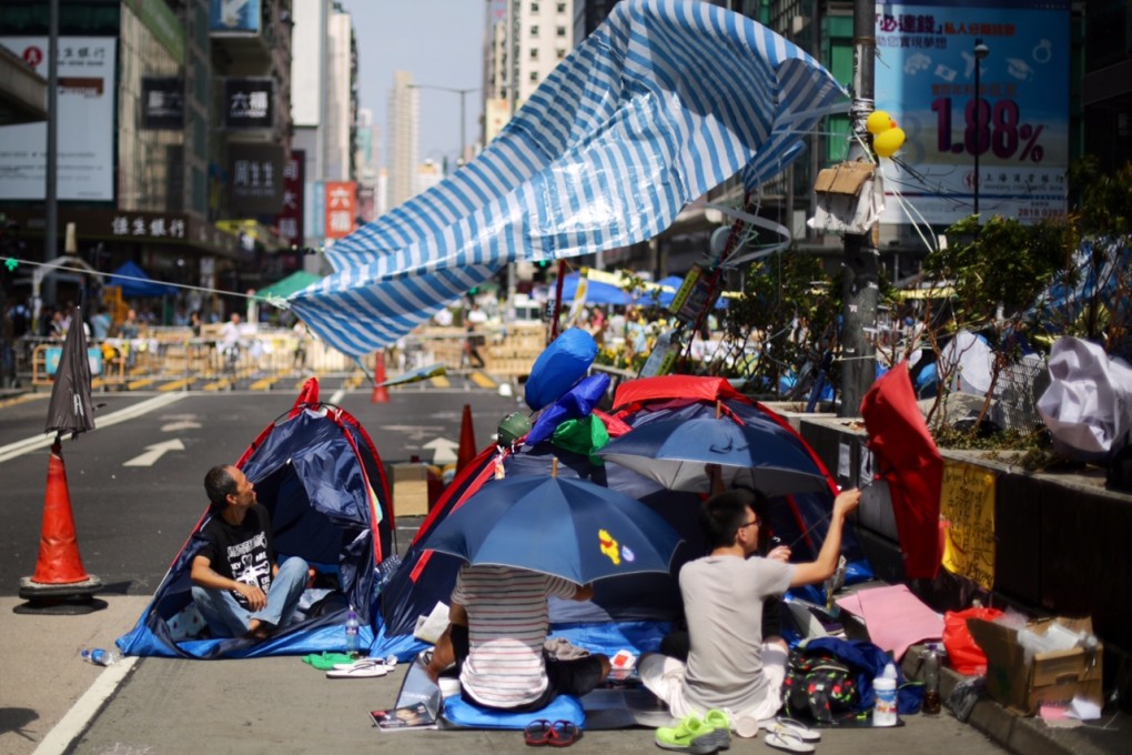 A gust of wind catches a pro-democracy protester's shelter in Mong Kok on Tuesday, Photo: Sam Tsang
