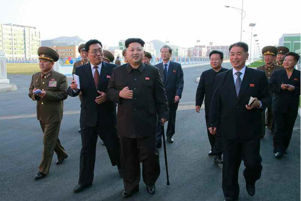 Kim Jong-un walks with a cane this month. Photo: EPA