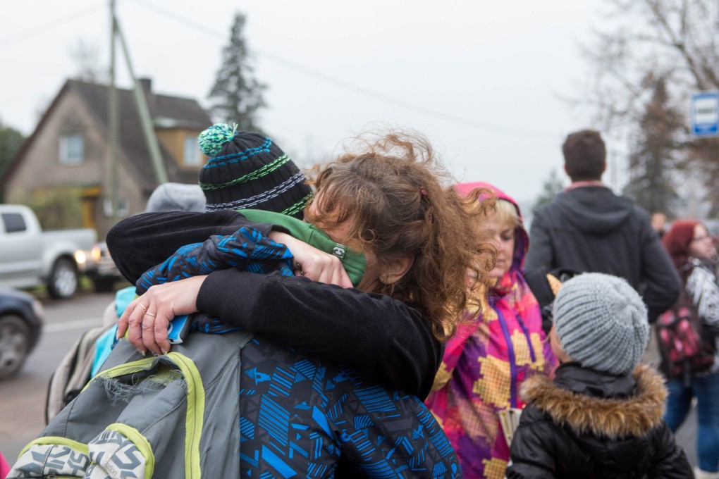 A pupil is comforted by his mother after he went out of the school where a teacher was shot dead by a teenager in Viljandi, southern Estonia. Photo: AFP