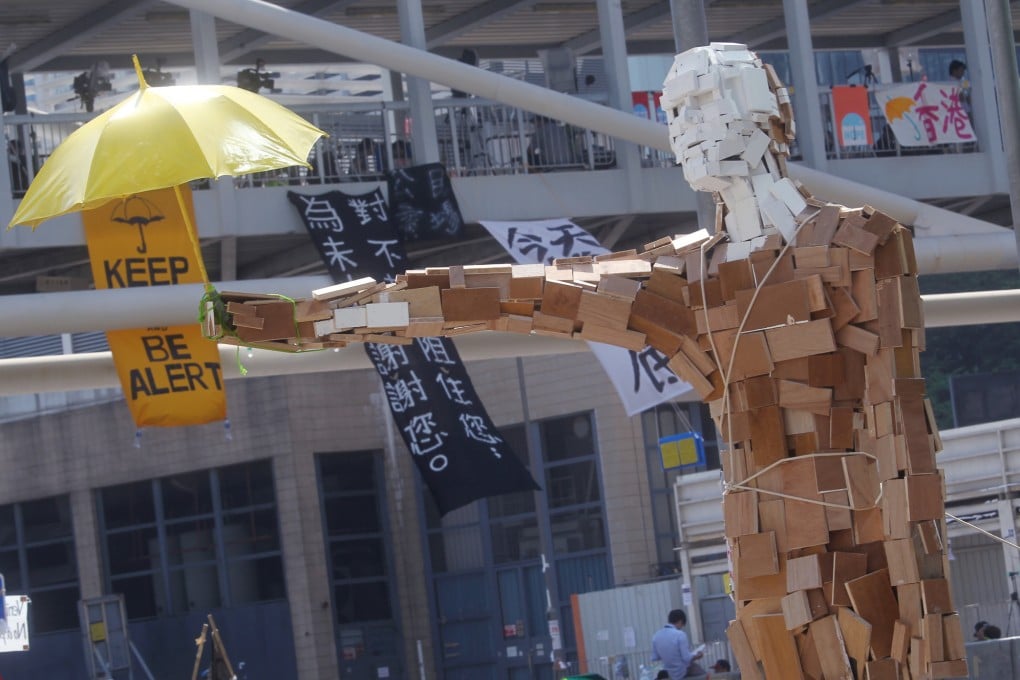 The statue "Umbrella Man" by the Hong Kong artist known as Milk, stands at a protest site next to the central government offices in Admiralty. Photo: SCMP/May Tse