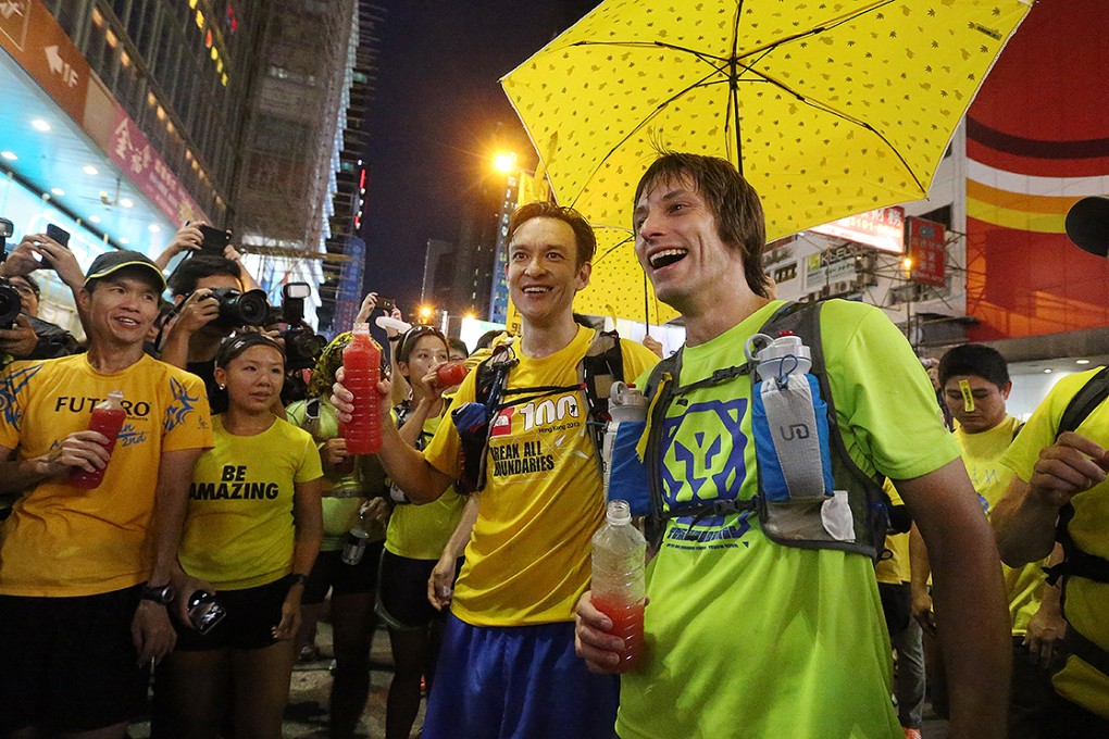 John Ellis (front left ) and Andrew Dawson arrive Mong Kok after they ran an ultramarathon course in the shape of a giant umbrella to support ongoing pro-democracy protests. Photo: K. Y. Cheng