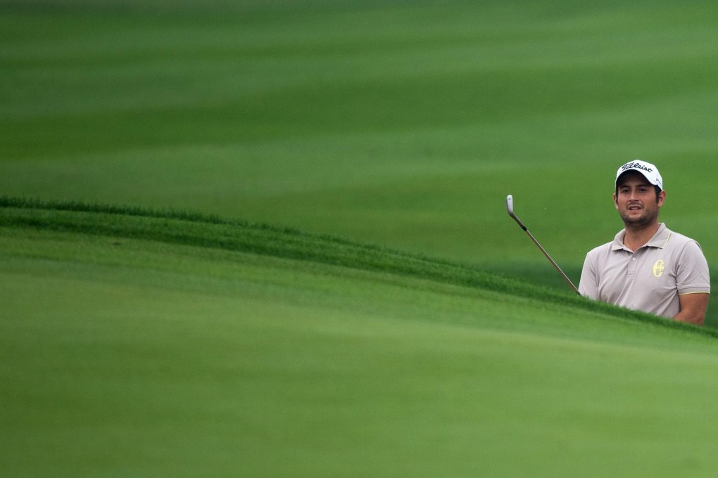 Alexander Levy considers a shot out of the bunker at the 7th hole during the BMW Shanghai Masters tournament at the Lake Malaren club. Photo: AFP
