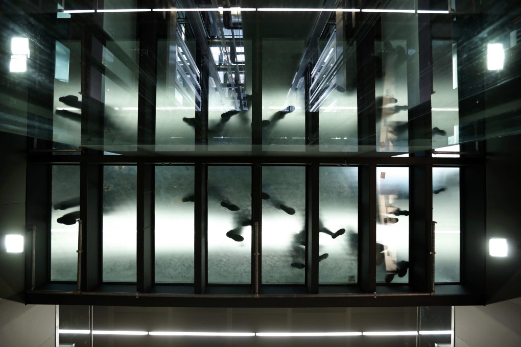 People walk on a glass-bottomed passageway at Vienna's new main train station, which opened earlier this month. Photo: Reuters