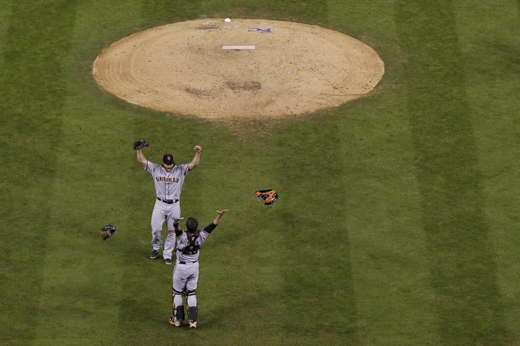 San Francisco Giants' pitcher Madison Bumgarner and catcher Buster Posey celebrate after they win the World Series. Photo: AP
