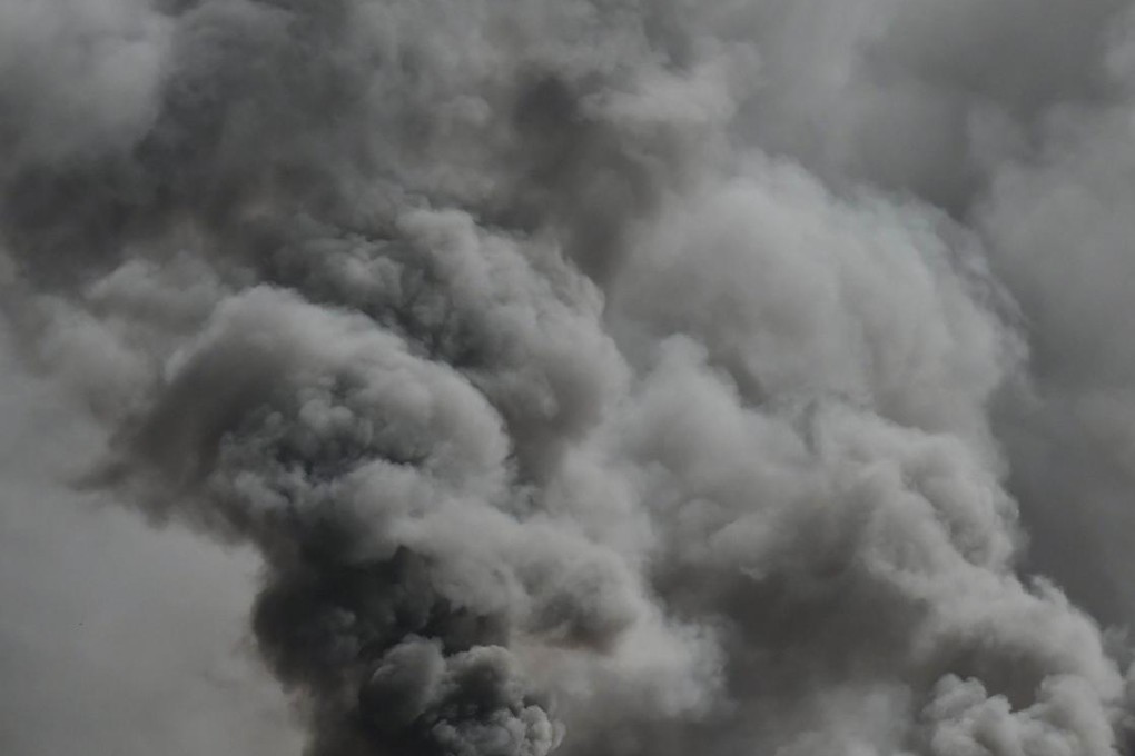 The scene in front of parliament yesterday in Ouagadougou. About 1,500 people had breached a security cordon and were ransacking the building. Photo: AFP