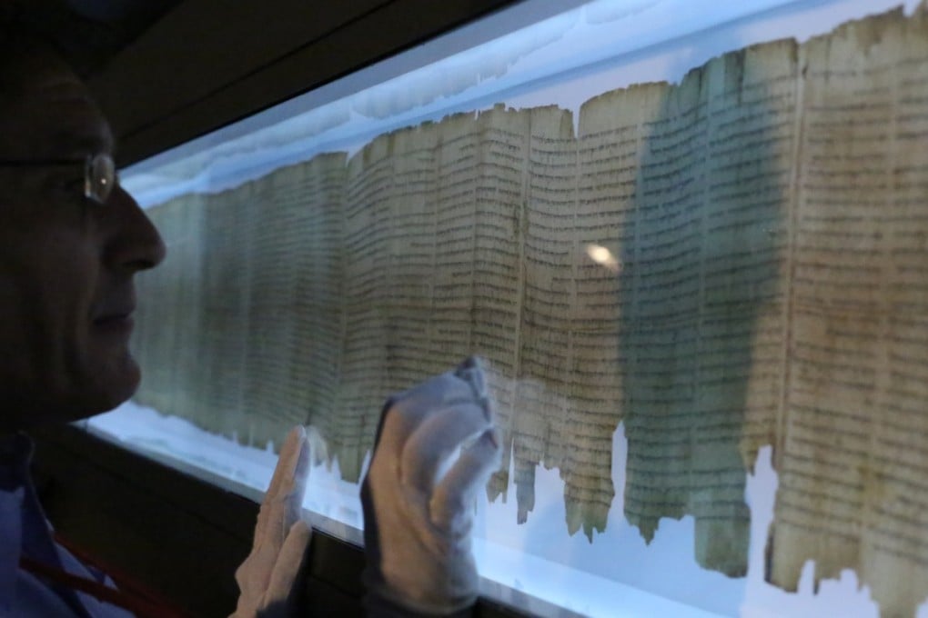 Dr Adolfo Roitman with the Great Scroll of Isaiah. Photo: Nora Tam