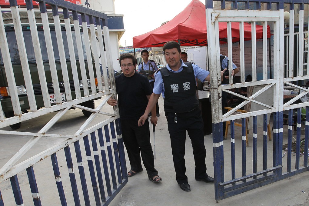 Armed guards at the gates of the police station in the Xinjiang city of Hotan, where mayor Adil Nurmemet is under investigation for graft. Photo: SCMP Pictures