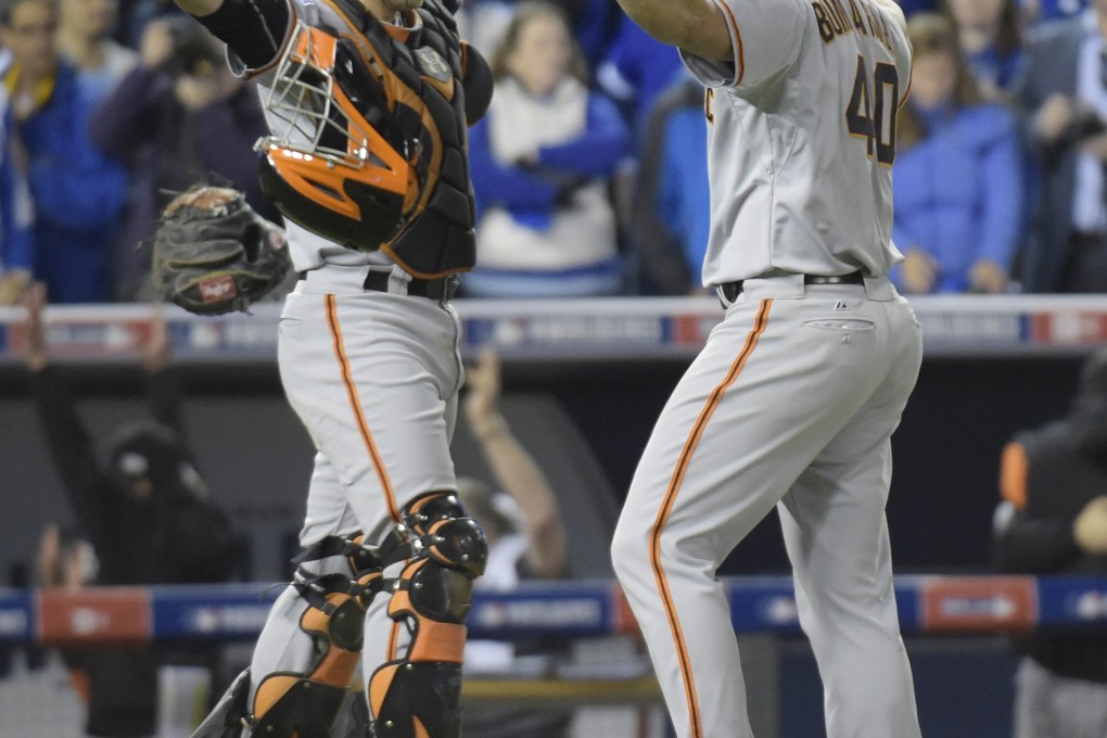 San Francisco Giants Madison Bumgarner (right) and Buster Posey celebrate after defeating the Kansas City Royals 3-2 in game seven of the World Series. Photo: EPA