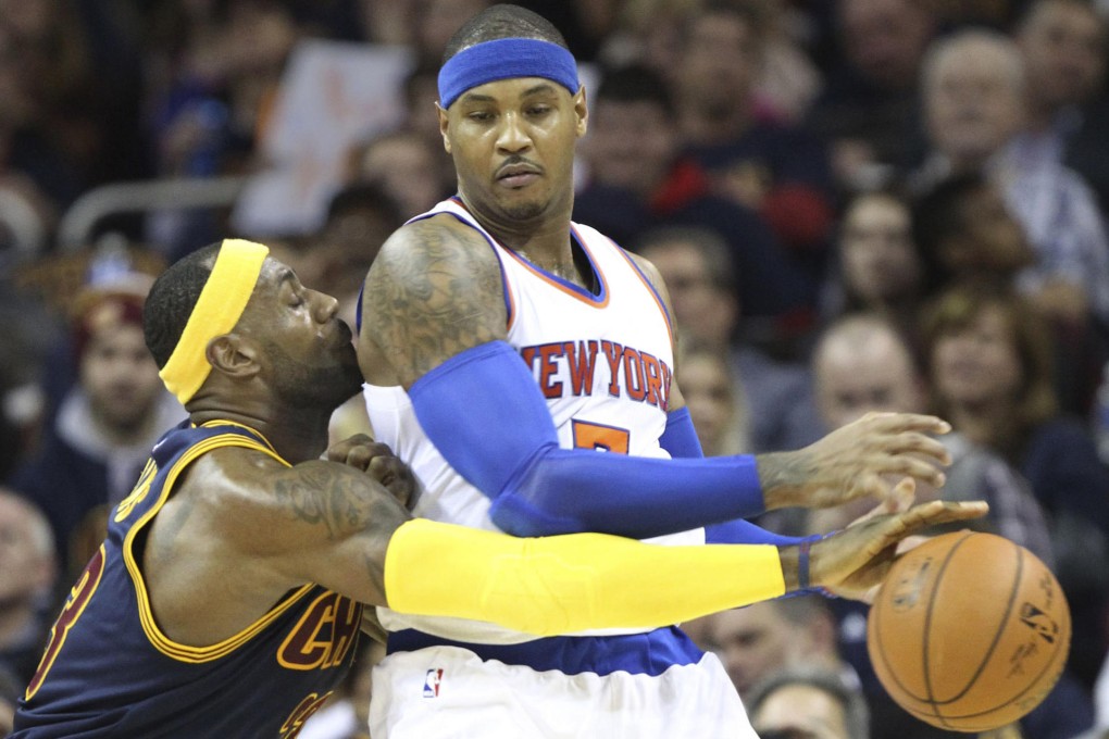 LeBron James, in his debut for the Cleveland Cavaliers, strips the ball from the New York Knicks’ Carmelo Anthony at Quicken Loans Arena. Photo: MCT