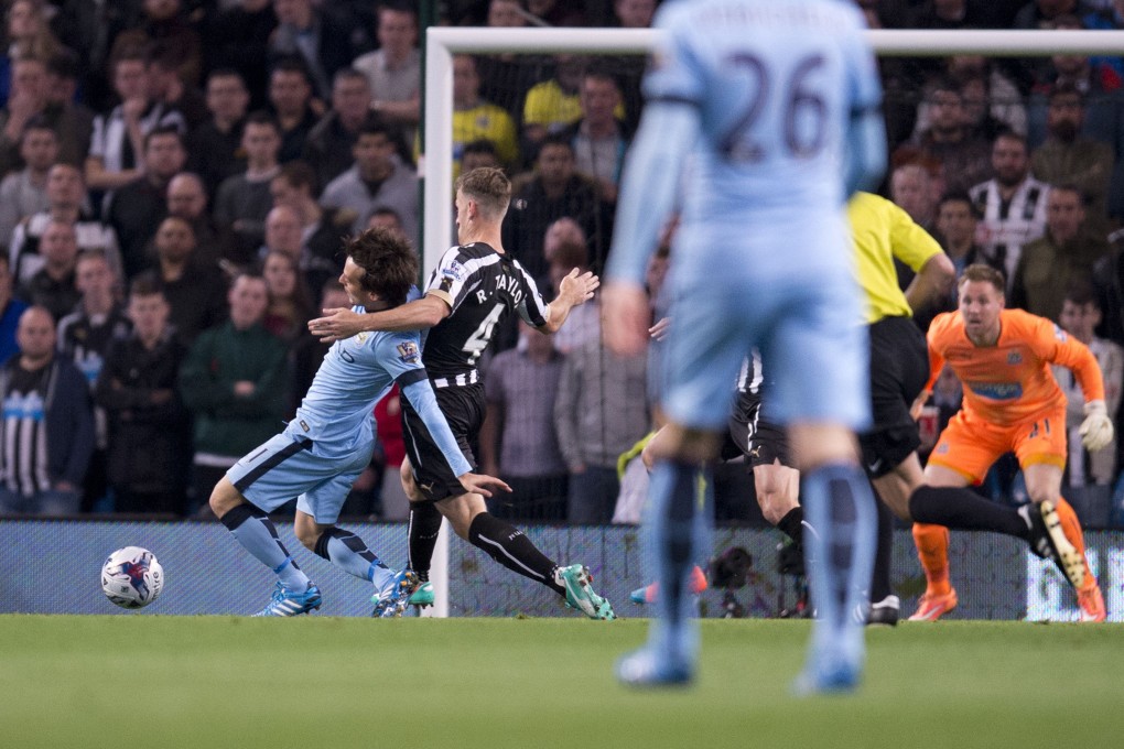 Manchester City's David Silva is challenged by Newcastle United's Ryan Taylor resulting in the Spanish midfielder's injury and subsequent substitution in their League Cup match. Photo: AFP