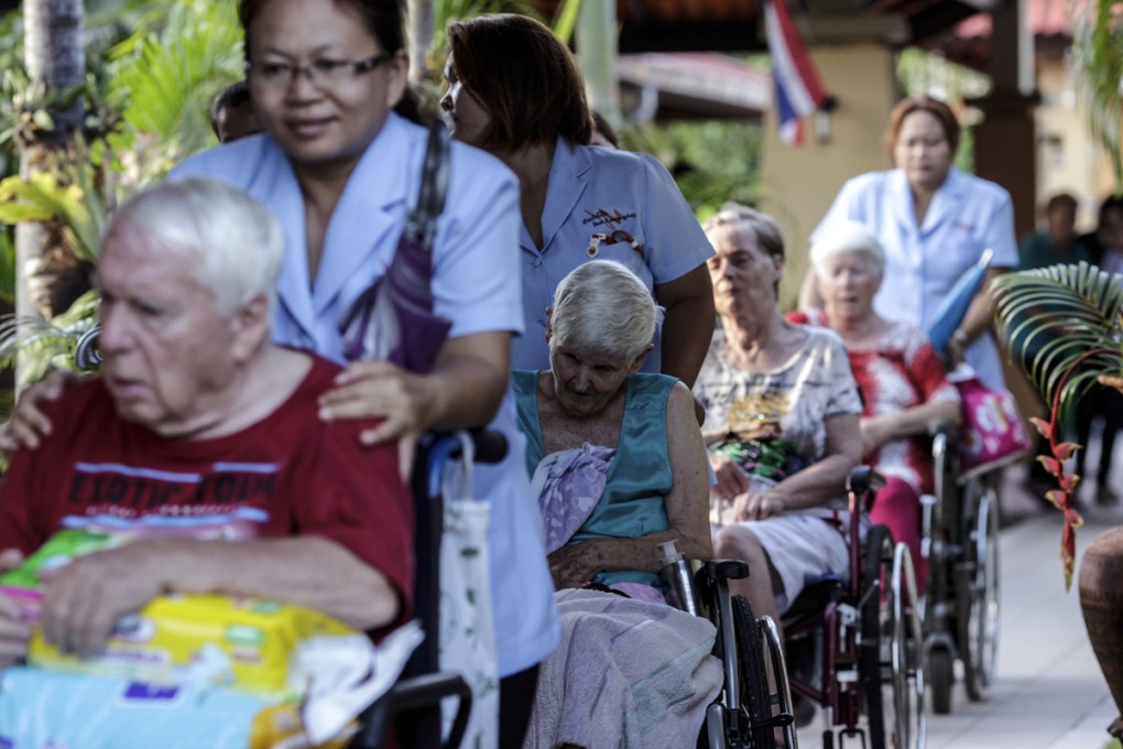 Guests and their caregivers at the Baan Kamlangchay care home, in Faham, near Chiang Mai.