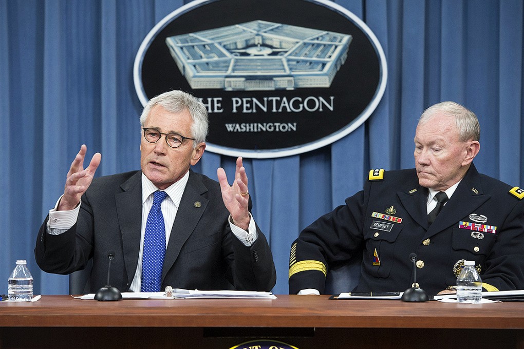 US Secretary of Defence Chuck Hagel and Chairman of the Joint Chiefs of Staff General Martin Dempsey discuss the battle against the Islamic State at a Pentagon news briefing on Friday. Photo: EPA