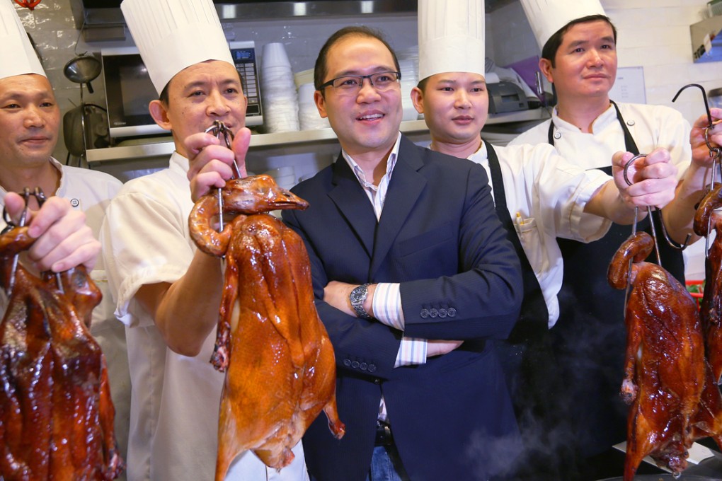 Hardy Kam celebrates with his chefs the awarding of a Michelin star to Kam’s Roast Goose restaurant in Wan Chai. Photo: Nora Tam