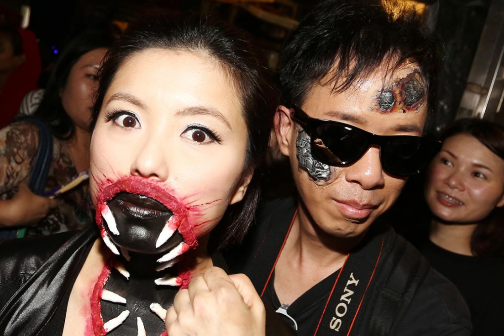 Revellers in fancy dress enjoy the Halloween fun on Lan Kwai Fong's busiest night of the year. Photo: Jonathan Wong