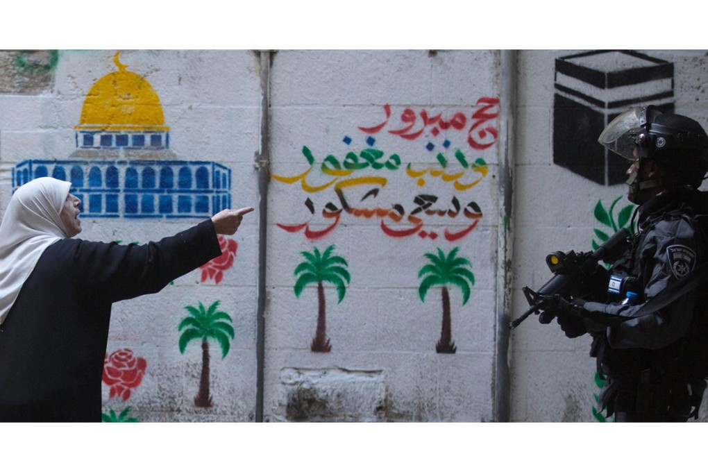 A Palestinian woman shouts at an Israeli police officer in Jerusalem's Old City. The al-Aqsa mosque is the third holiest site in Islam. Photo: AFP