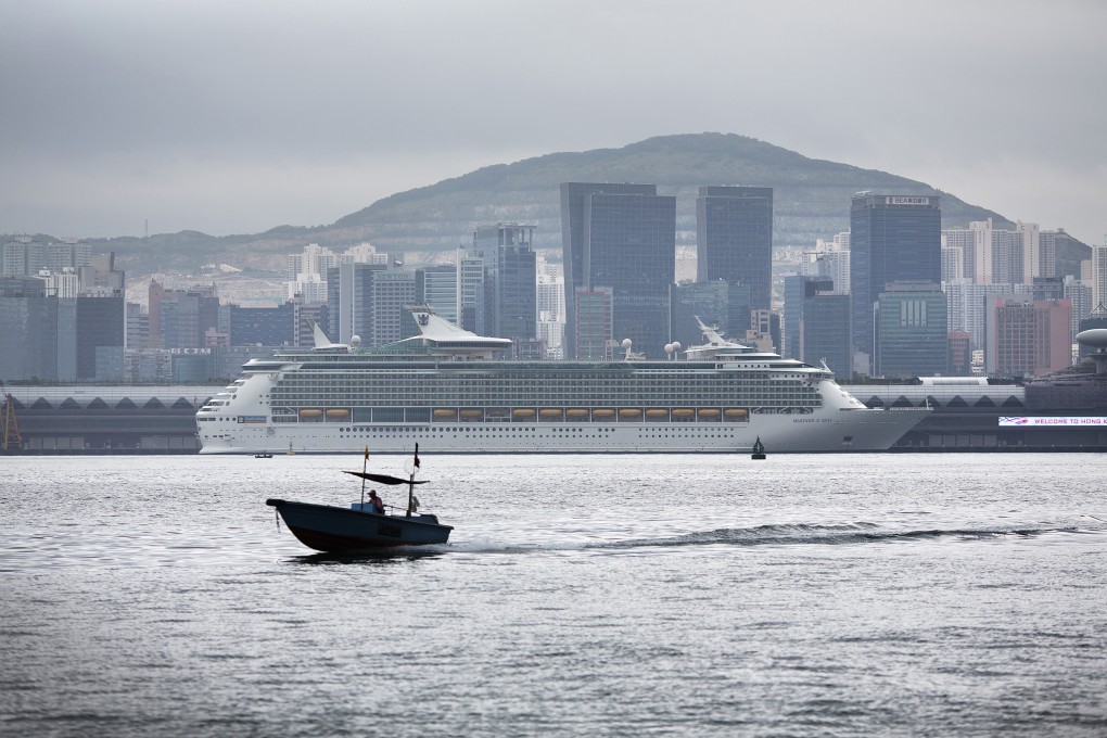 A boat sails past Royal Caribbean Cruises Ltd.'s Mariner of the Seas ocean liner, berthed at the Kai Tak Cruise Terminal, in Hong Kong. Photo: Bloomberg