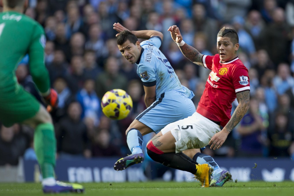 City's goalscorer Sergio Aguero (centre) is challenged by United's Marcos Rojo in their Premier League clash at Etihad Stadium. Photo: Reuters