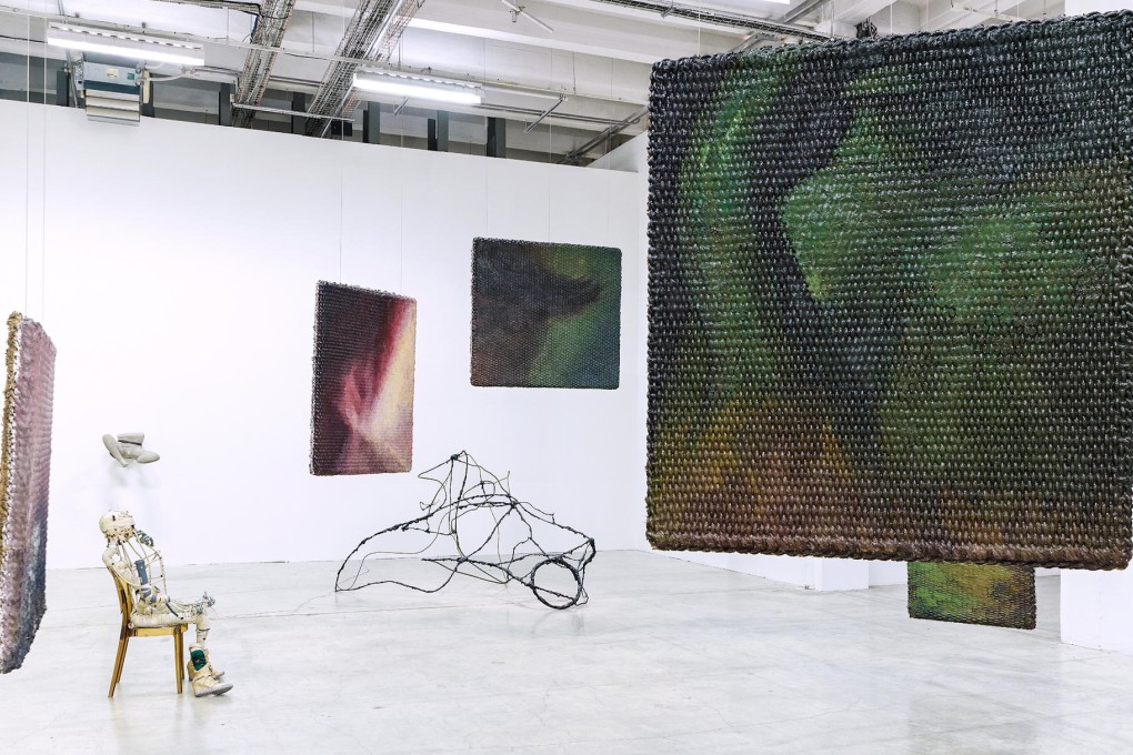 Renaud Jerez's "D — 2014" (PVC model sitting on a chair on the left), Li Gang's "Green Vase — 2012" (large rug-like hemp canvasses) and Zhao Yao's "I am Your Night No 10" (abstract swirling piece in the middle) form part of the "Inside China" exhibition at Palais de Tokyo in Paris.
