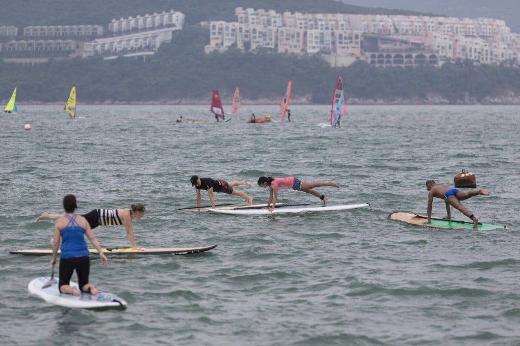 From left: Donna Cornish, Sasha Southwell, coach Jason Clark, health editor Jeanette Wang and Rye Bautista at a training session off Stanley Main Beach.