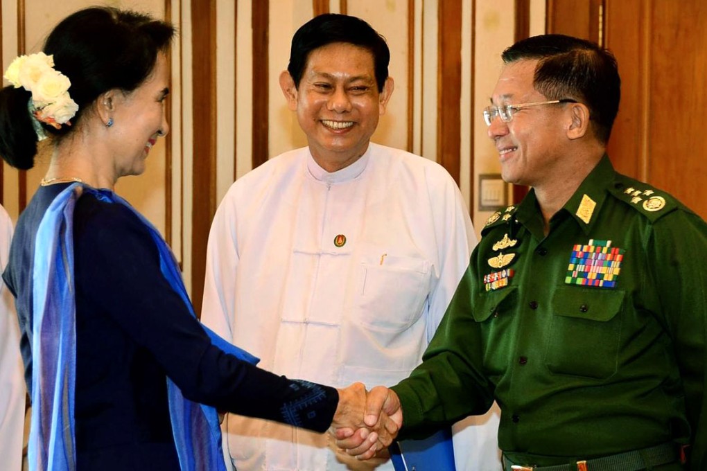 Suu Kyi greets army chief Min Aung Hlaing as parliamentary speaker Thura Shwe Mann looks on. Photo: EPA