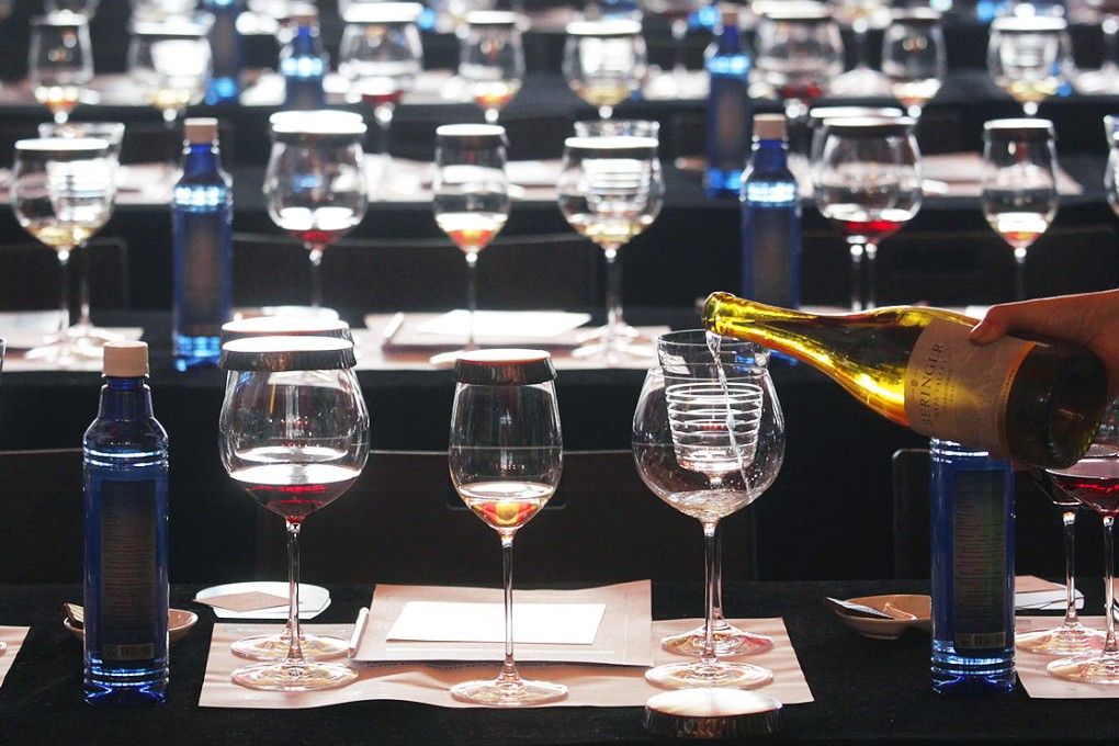 Glasses are set out for a tasting session. Many customers were spending less at the festival's new venue at remote Kai Tak. Photo: Dickson Lee