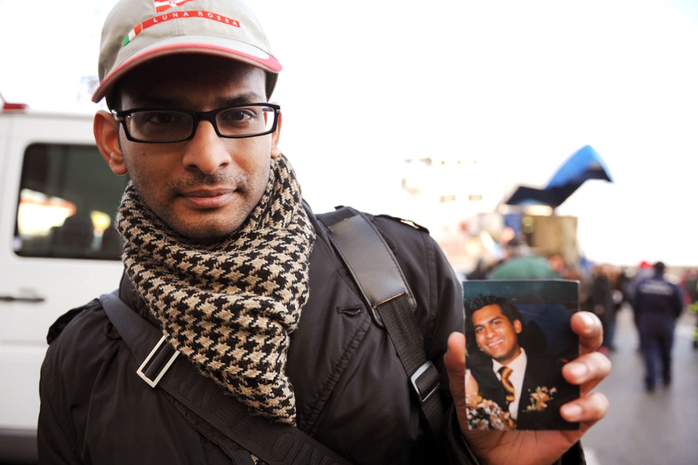 Kevin Rebello with a picture of his brother, Russel Rebello. Photo: AFP