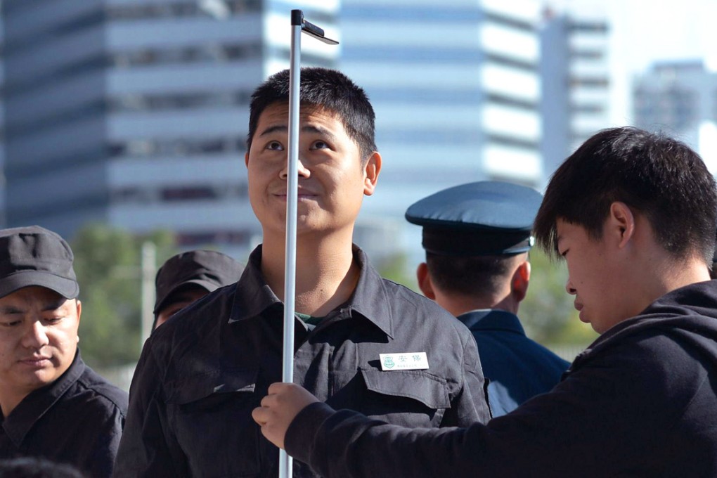 Security personnel get a quick check up ahead of this week's Apec meetings in Beijing. Photo: AFP