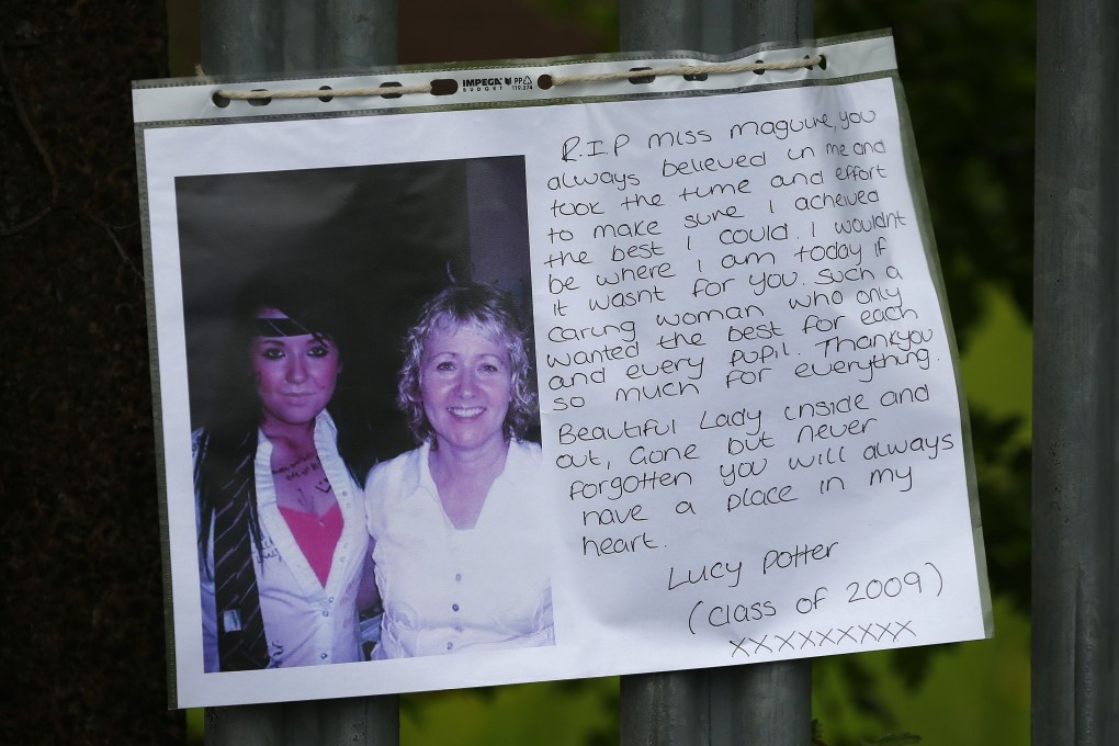 A photograph of teacher Ann Maguire (right), who was fatally stabbed, hangs from the fence of Corpus Christi Catholic College in Leeds. Photo: Reuters