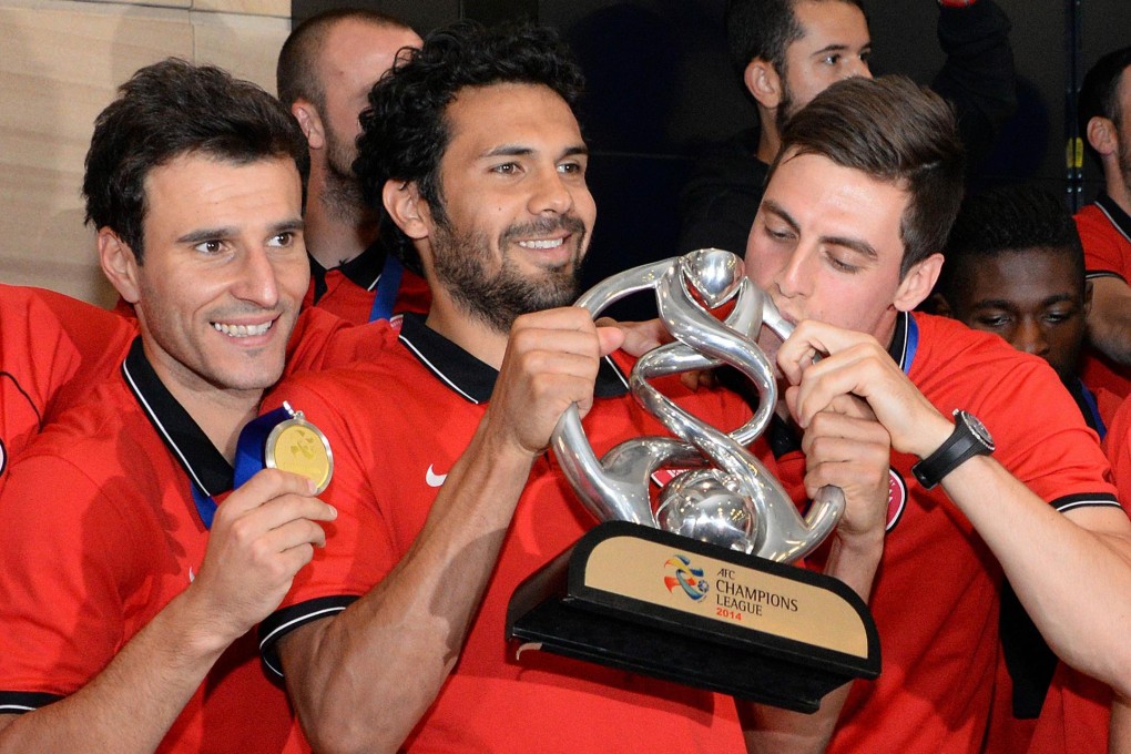 Western Wanderers captain Nikolai Topor-Stanley (centre) celebrates with teammates as they arrive in Sydney with the AFC Champions League trophy. Photo: AFP