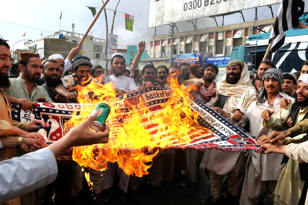 Supporters of the Pakistani Taliban burn a US flag during a protest in May 2014 on the third anniversary of the death of slain al-Qaeda leader Osama bin Laden. Photo: AFP