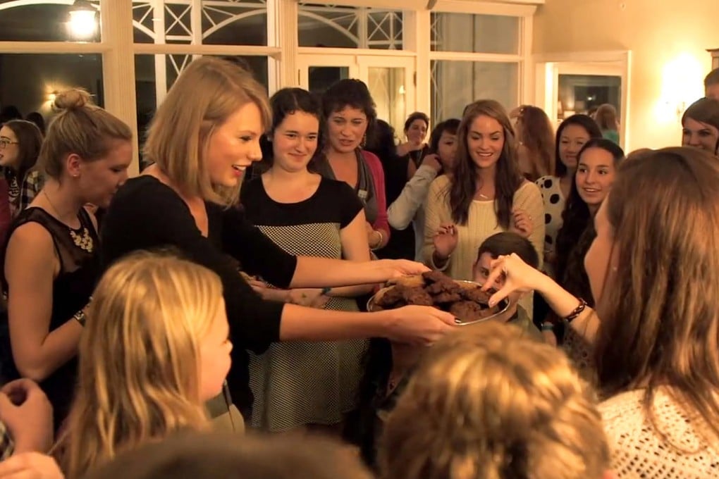 Taylor Swift hands out treats to a select group of fans during one of the singer's "secret sessions" held to promote her latest album.