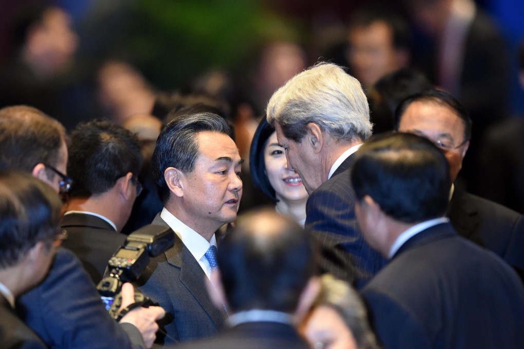Foreign Minister Wang Yi talks informally with US Secretary of State John Kerry yesterday ahead of next week's gathering of the 21 Apec leaders in Beijing. Photo: Xinhua